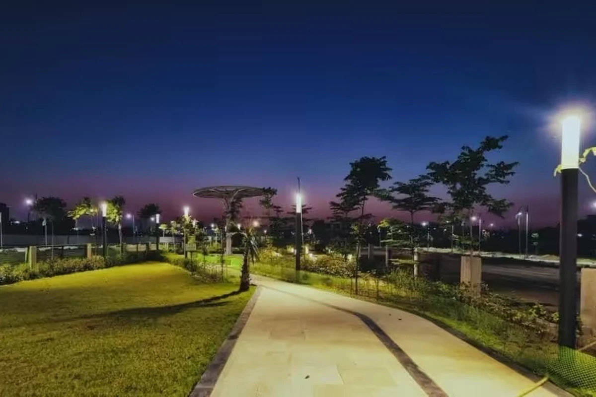 Street-lit internal walkway through landscaped green zone at Mapsko ASPR Greenz Sector 35 Sonipat